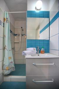 a bathroom with a sink and a shower with a mirror at Pelagos in Stafylos +37 photos