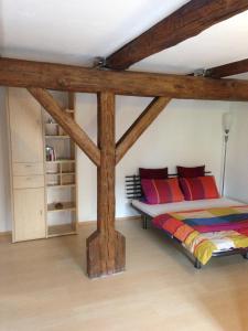 a bedroom with a bed with wooden beams at Apartment Regensburg in Regensburg