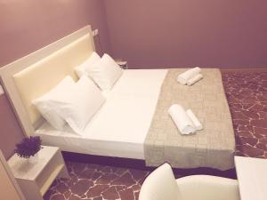 Postel nebo postele na pokoji v ubytování Hotel Paganini