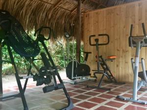 a gym with several exercise bikes and tread machines at Palomino Breeze Hostal in Palomino