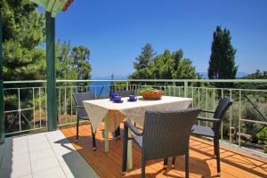 a patio with a table and chairs on a deck at Pelagos in Stafylos