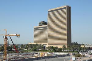 a tall building with a crane in front of it at Deema Hotel in Dubai
