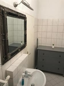 a white bathroom with a sink and a mirror at Apartment Erfurt Mitte in Erfurt