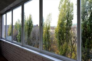 a row of windows in a room with trees at MEGAPOLIS улица Арсенальная 4-А-136 in Voronezh
