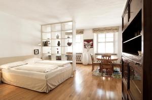 a bedroom with a large bed and a table at Residence Fink Central Apartments in Bolzano