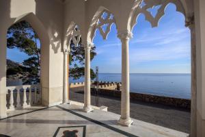 a view of the ocean from the porch of a building at Starhost - CASTLE MEZZACAPO in Minori