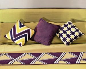 a couch with four pillows on it at Hotel Della Piccola Marina in Capri