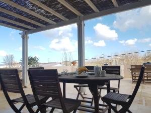 a dining table and chairs on a patio at Rastoni Apartments in Kissamos