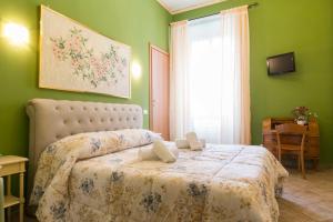 a bedroom with a bed in a green room at Albachiara Guest House in Rome