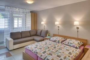 a bedroom with a large bed and a large window at Apartements Studio 964 in Líbeznice