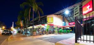 a city street at night with a building at Diplomat Hotel Alice Springs in Alice Springs