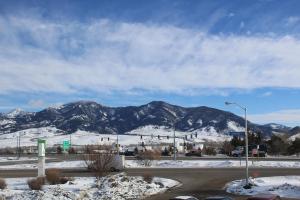 a snow covered mountain with a mountain range at 3 Rivers Hotel in Bozeman
