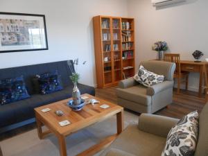 a living room with a couch and a coffee table at Lakeview in Bridgetown