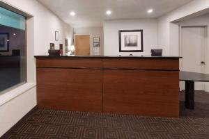 a room with a large wooden desk in a building at Super 8 by Wyndham Fort Bragg in Fort Bragg
