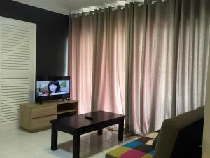 a living room with a tv and a coffee table at D’Savoy @ Famosa by SH in Melaka