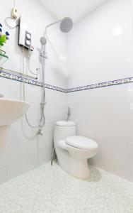 a bathroom with a toilet and a shower at Kim Lien's Homestay in Ho Chi Minh City