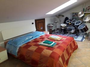 a bedroom with a bed with drums and percussion equipment at Ospitalità in Campagna in Quiliano