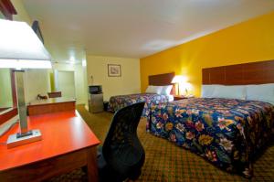 A bed or beds in a room at Passport Inn and Suites - Middletown