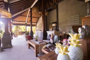 a room with tables and vases in a building at Masia Villa Ubud in Ubud