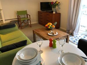 a living room with a table with two wine glasses at Coast Apartment in Sidmouth