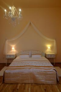 a bedroom with a large bed with two night stands at Leier apartments in Piešťany