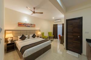 a bedroom with a bed and a table and chairs at Daffodil Delight - Manyata Tech Park in Bengaluru +53 photos