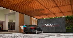 a black car parked in front of a building at PARKROYAL Penang Resort in Batu Ferringhi
