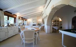 a dining room with a table and white chairs at Villa Gaia - Elegant Holiday Home in a sun and sea setting in Avola