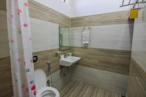 a bathroom with a toilet and a sink at Iora Guest House in Bharatpur +47 photos