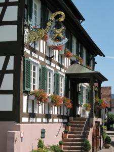 a building with a clock on the side of it at Gasthof Blume in Offenburg