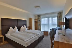 a hotel room with a bed and a desk at Gasthof Alpenblick in Amstetten