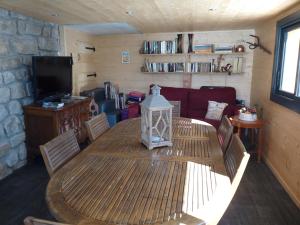 a living room with a wooden table and a couch at Les marmottes d Estenc in Estenc +31 photos