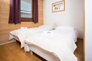 Ένα ή περισσότερα κρεβάτια σε δωμάτιο στο Le Paradis ski apartment - Chamonix All Year