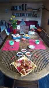 a wooden table with food on top of it at Les marmottes d Estenc in Estenc