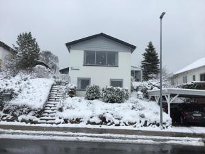 a white house with snow on the ground at Mit Bed & Breakfast in Kolding