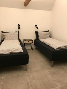 dos camas sentadas una al lado de la otra en una habitación en Gl.Hastrup Guesthouse en Køge