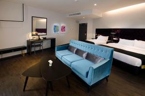 Postel nebo postele na pokoji v ubytování Palm Hotel Ipoh