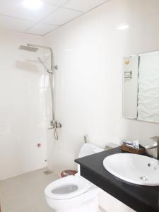 a bathroom with a white toilet and a sink at Phu Tien Hotel in Dong Hoi