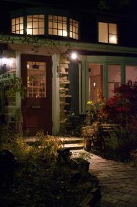 a house with a front door at night at Pension & Cafe Cruise in Shika