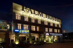 a large building with a sign for a hotel at Palm Hotel Ipoh in Ipoh