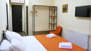 a room with a bed and a table with towels on it at Green Terrace in Tbilisi City