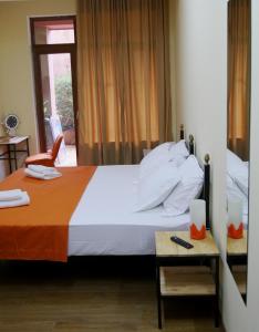a bedroom with a large bed with an orange blanket at Green Terrace in Tbilisi City