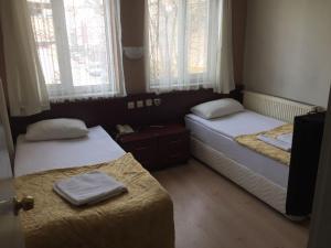 سرير أو أسرّة في غرفة في Sirin Hotel