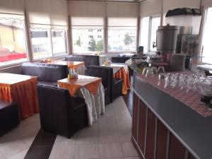 a restaurant with tables and chairs in a room at Sirin Hotel in Corum