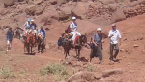 a group of people riding horses in the desert at Tizi Maison d'Hôtes in Telouet