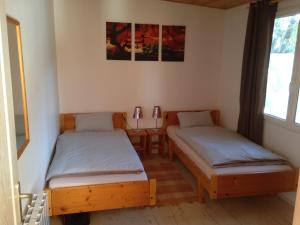 a room with two twin beds and a table at Chalet Beziers in Béziers