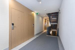 a hallway with a wooden door and a staircase at Hotel Londres Estoril / Cascais in Estoril
