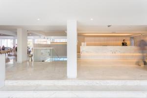 a person walking through a lobby of a building at Hotel Londres Estoril / Cascais in Estoril