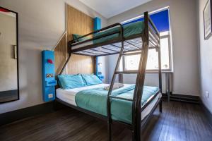 a bedroom with two bunk beds and a window at Kick Ass Greyfriars (18+) in Edinburgh +37 photos