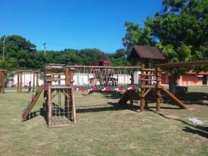 a park with a playground with a slide at kitnet da izumi in Cabo Frio